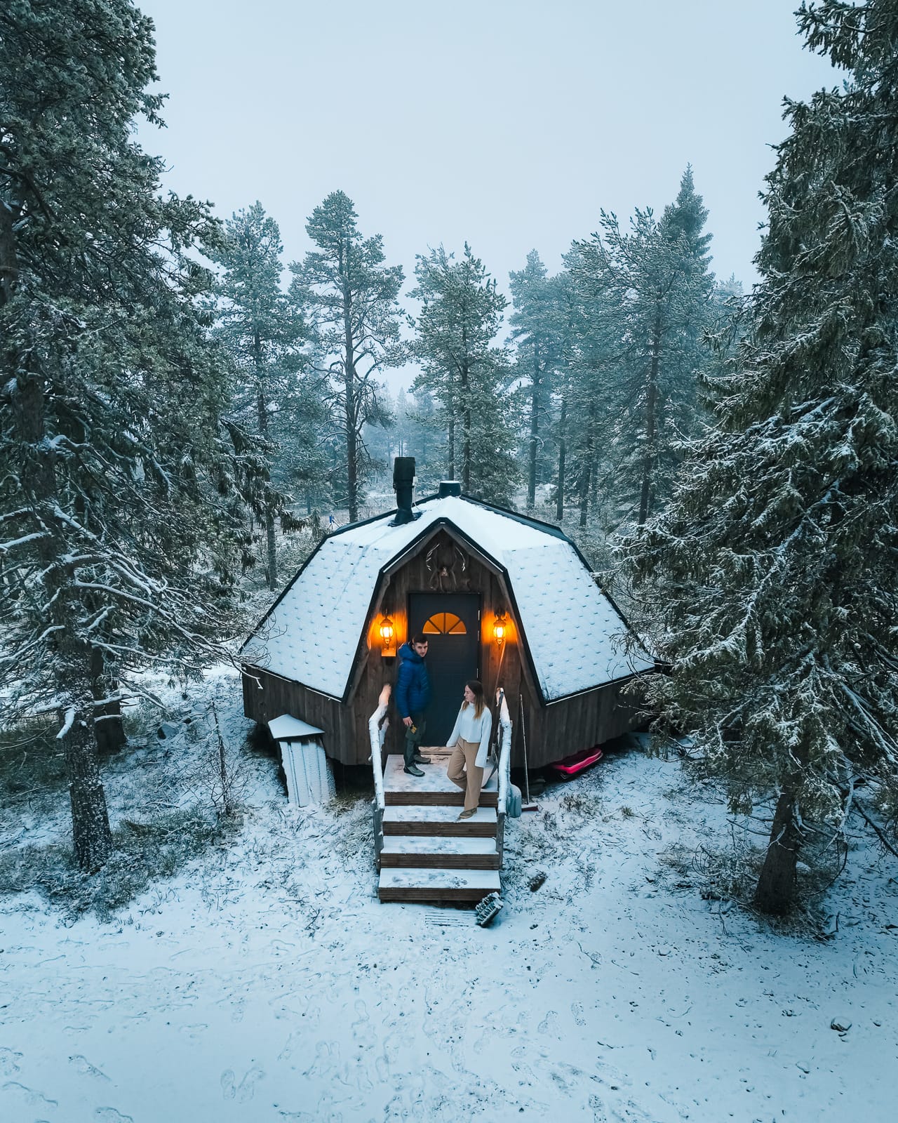 aerial view of igloo hotel surrounded by snowy trees at syote igloo in lapland
