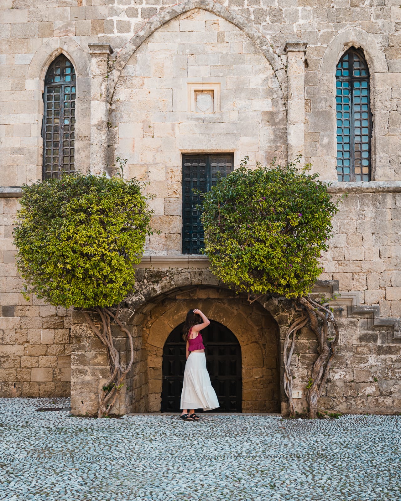 woman standing in door archway at Square of the Hebrew Martyrs
