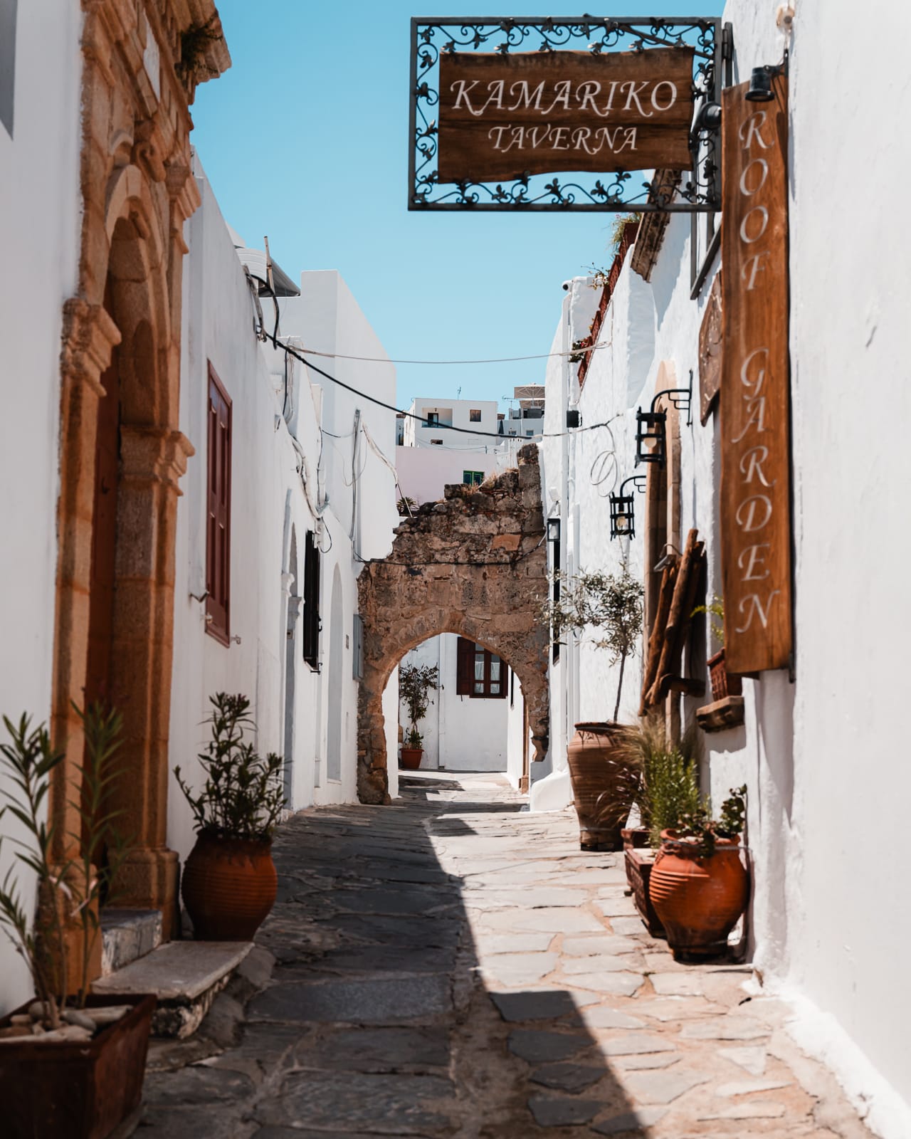 alleyway with stone archway in lindos village, rhodes