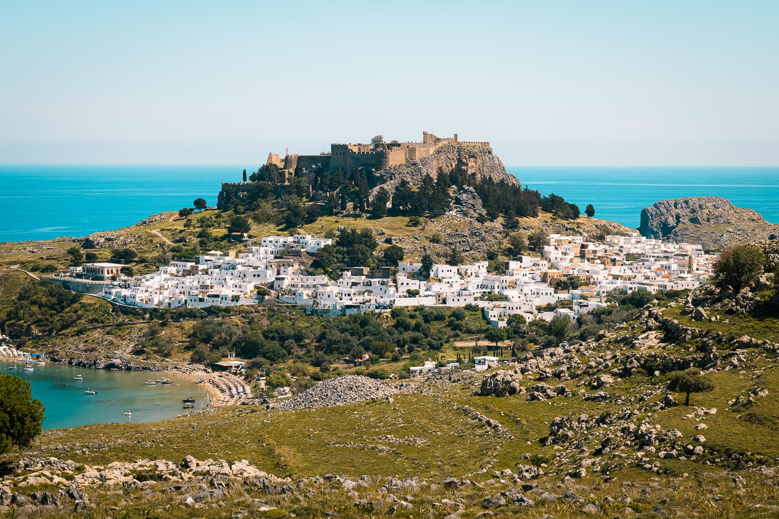 view of lindos white village and acropolis on the hill