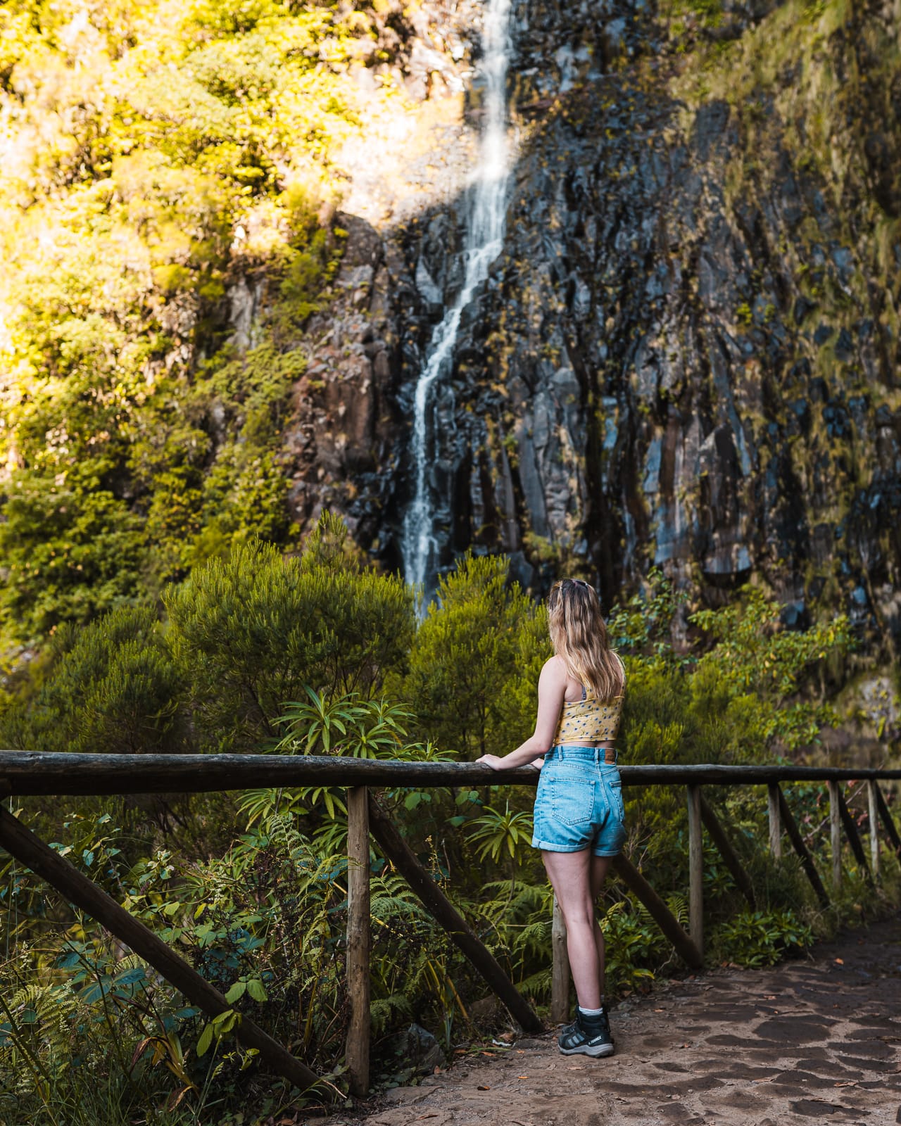 woman standing at 25 fontes watefall in madeira