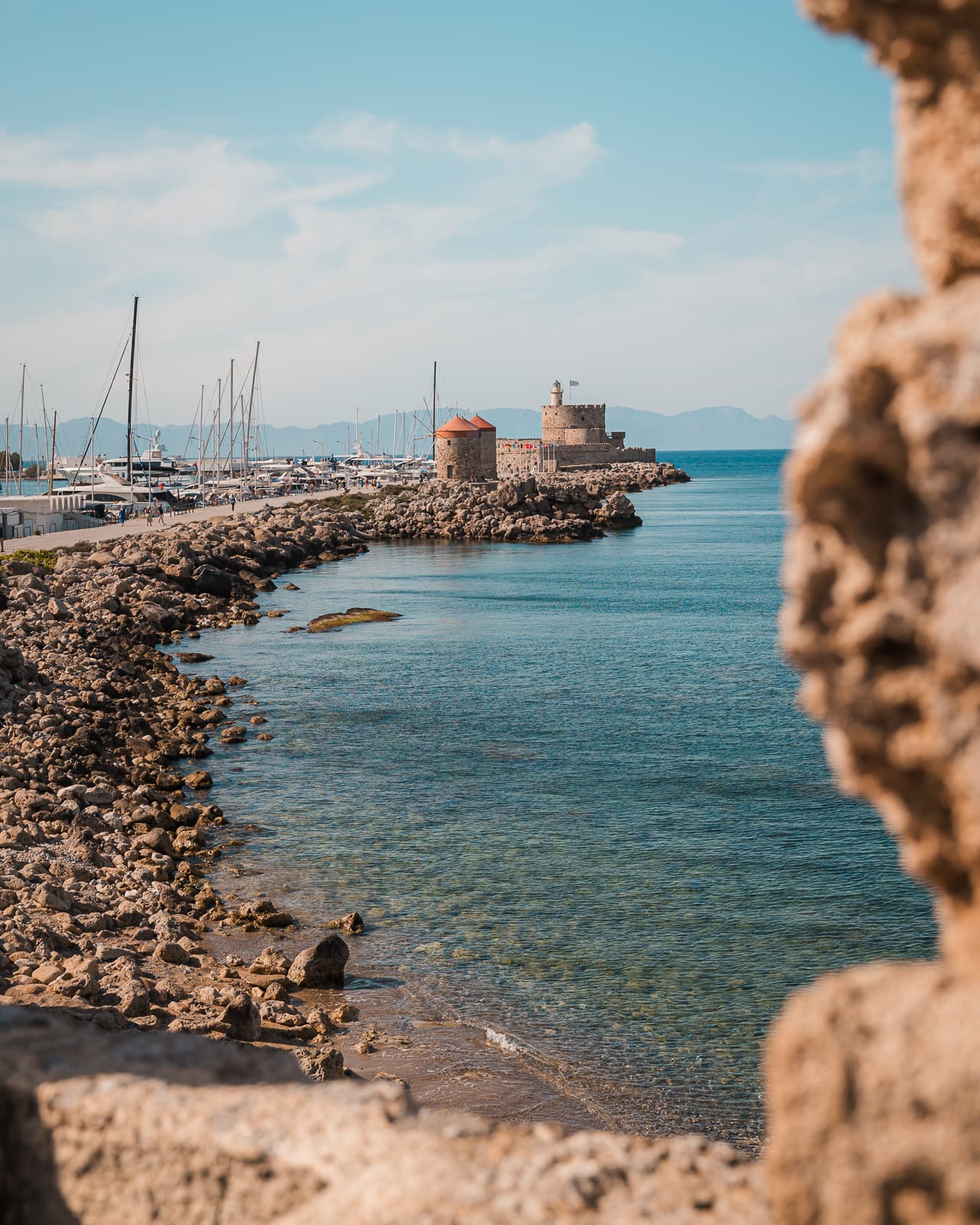 view of Rhodes Windmills on Mandaraki Harbour in Rhodes