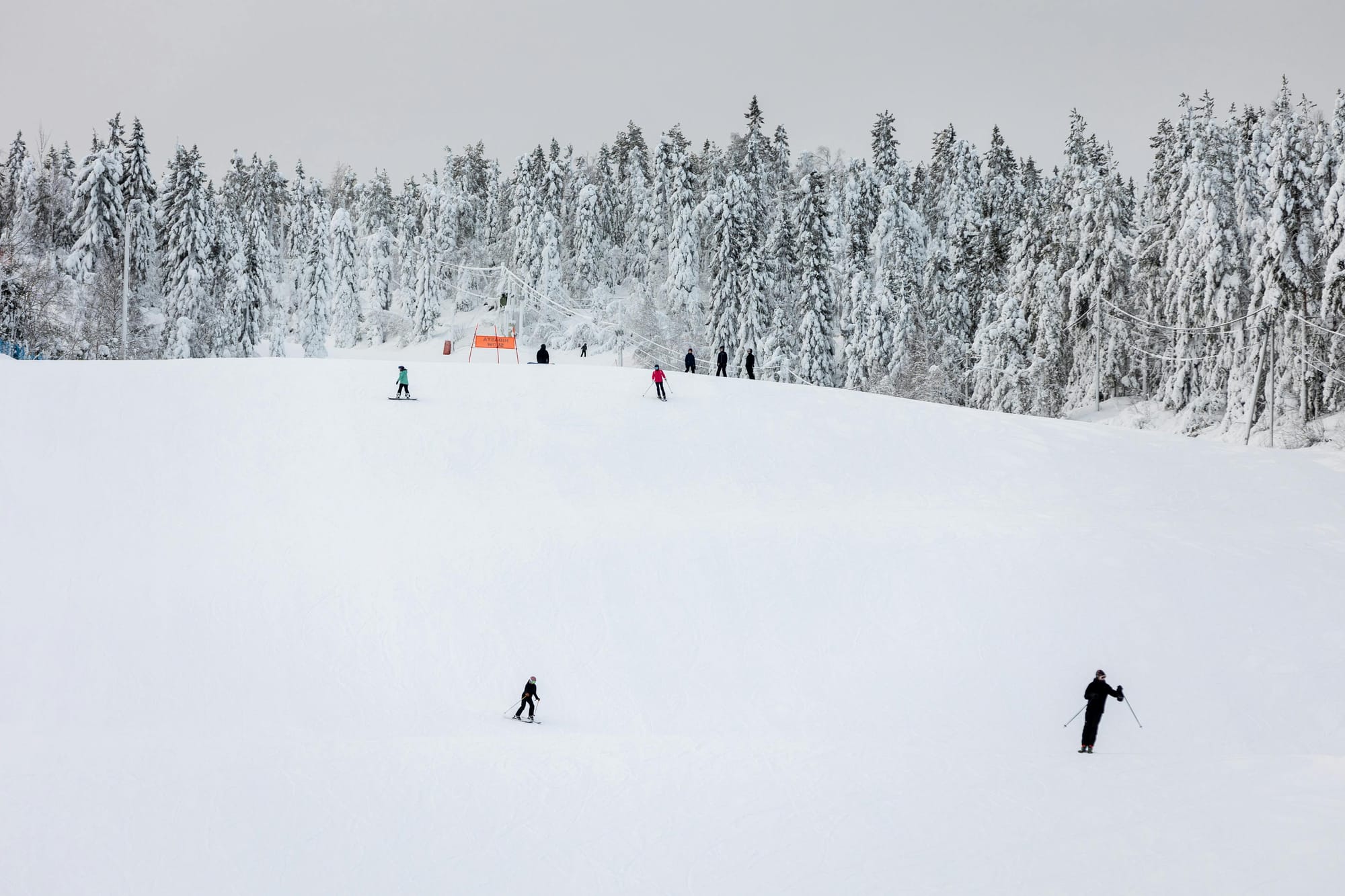 ski slope in finland with people skiing