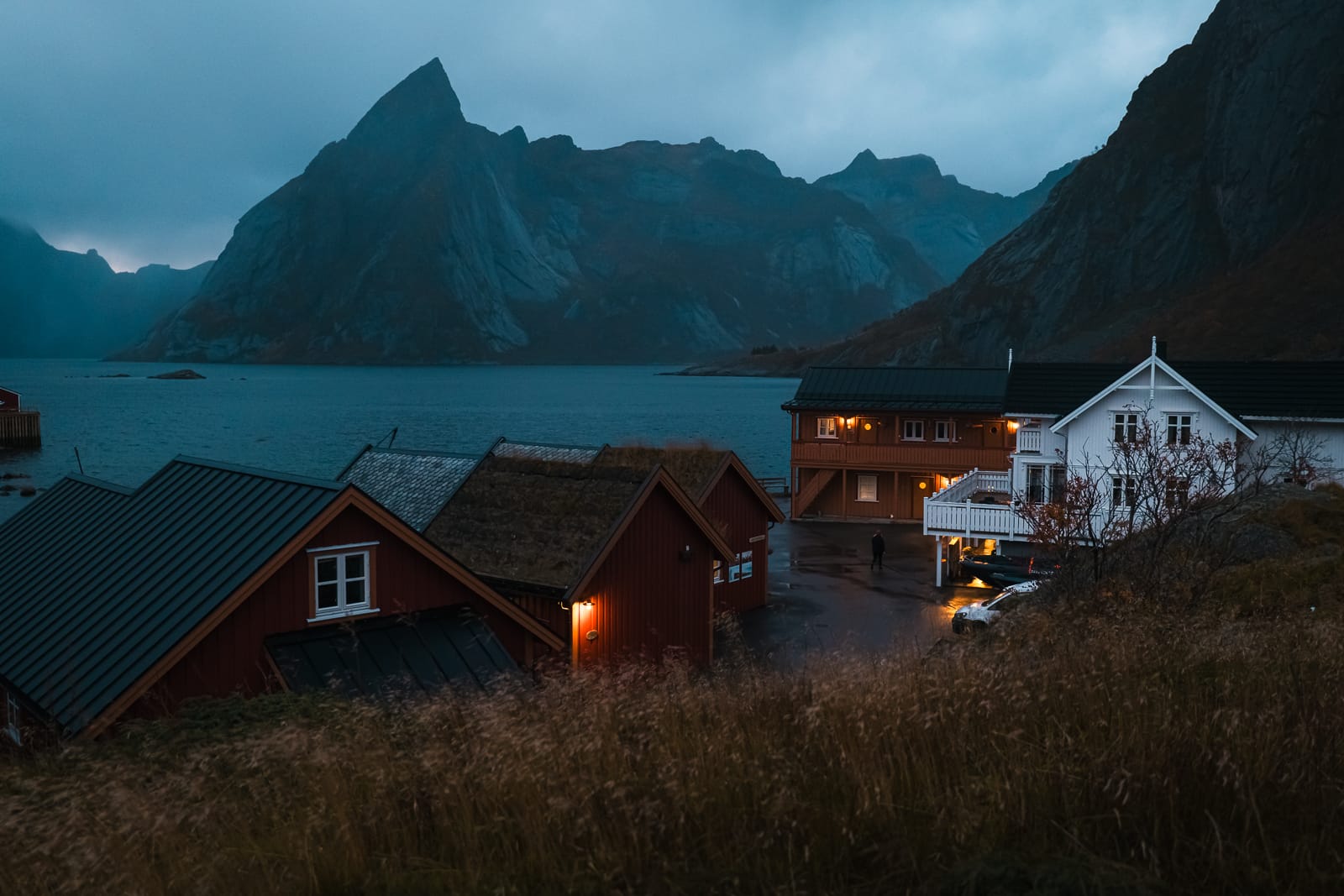 red rorbu cabins at Reinefjorden Sjohus in lofoten at blue hour