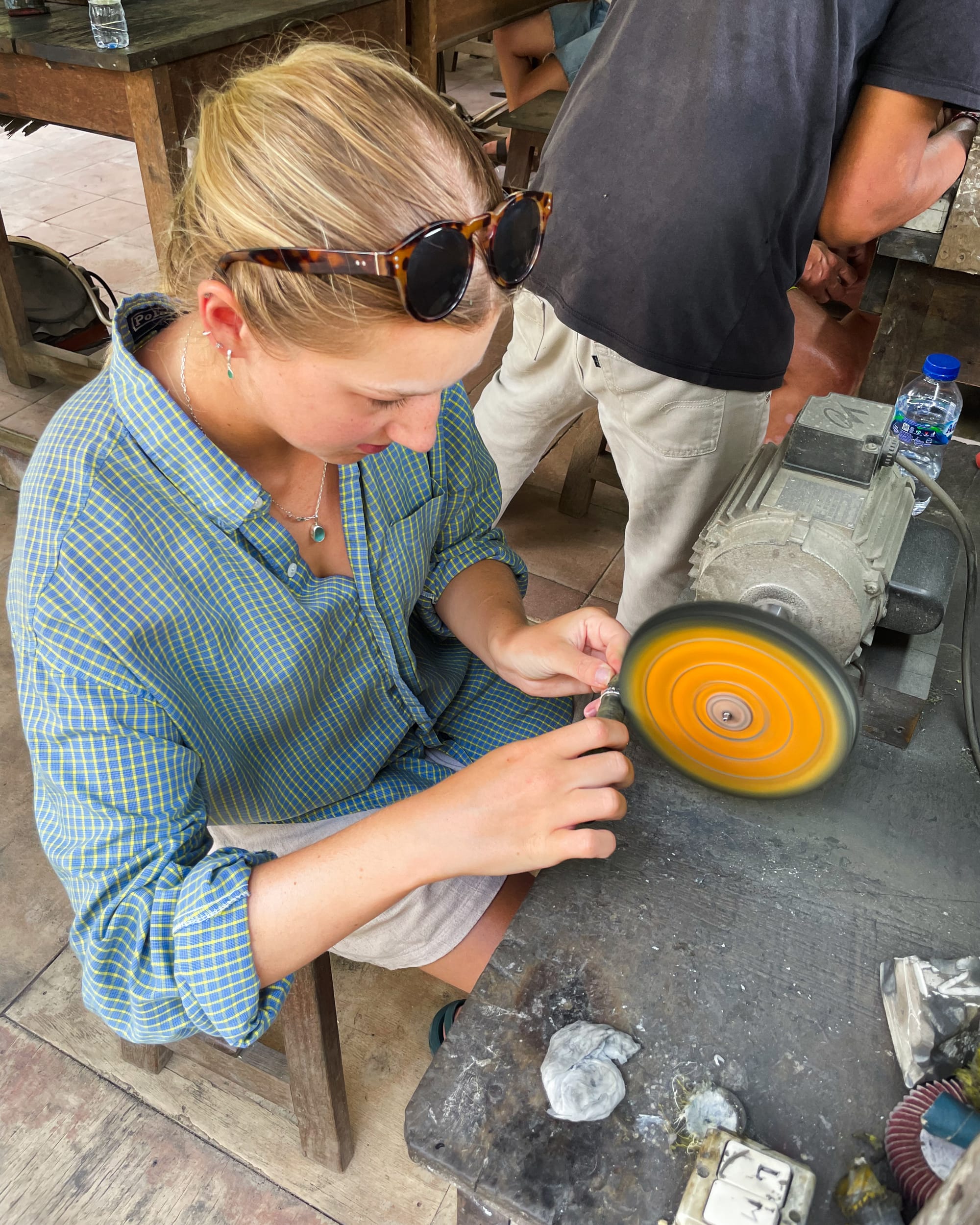 woman sanding ring at silver jewellery making class in bali