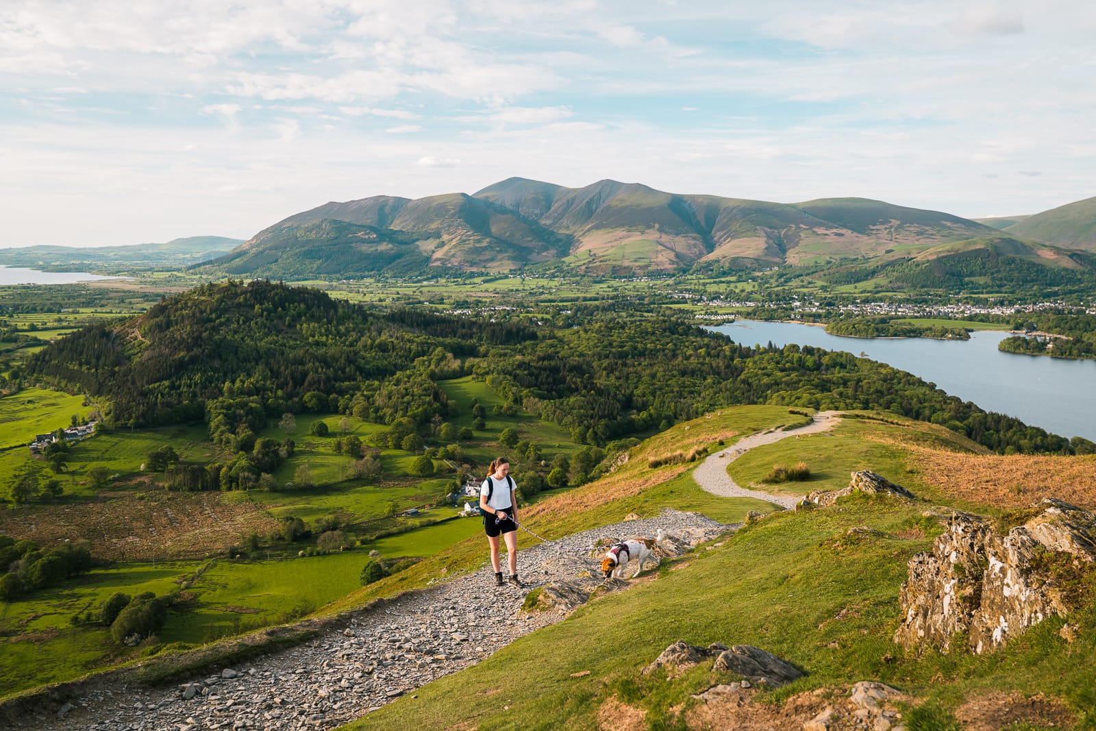 woman walking on path with mountains in background at cat bells hike in lake district