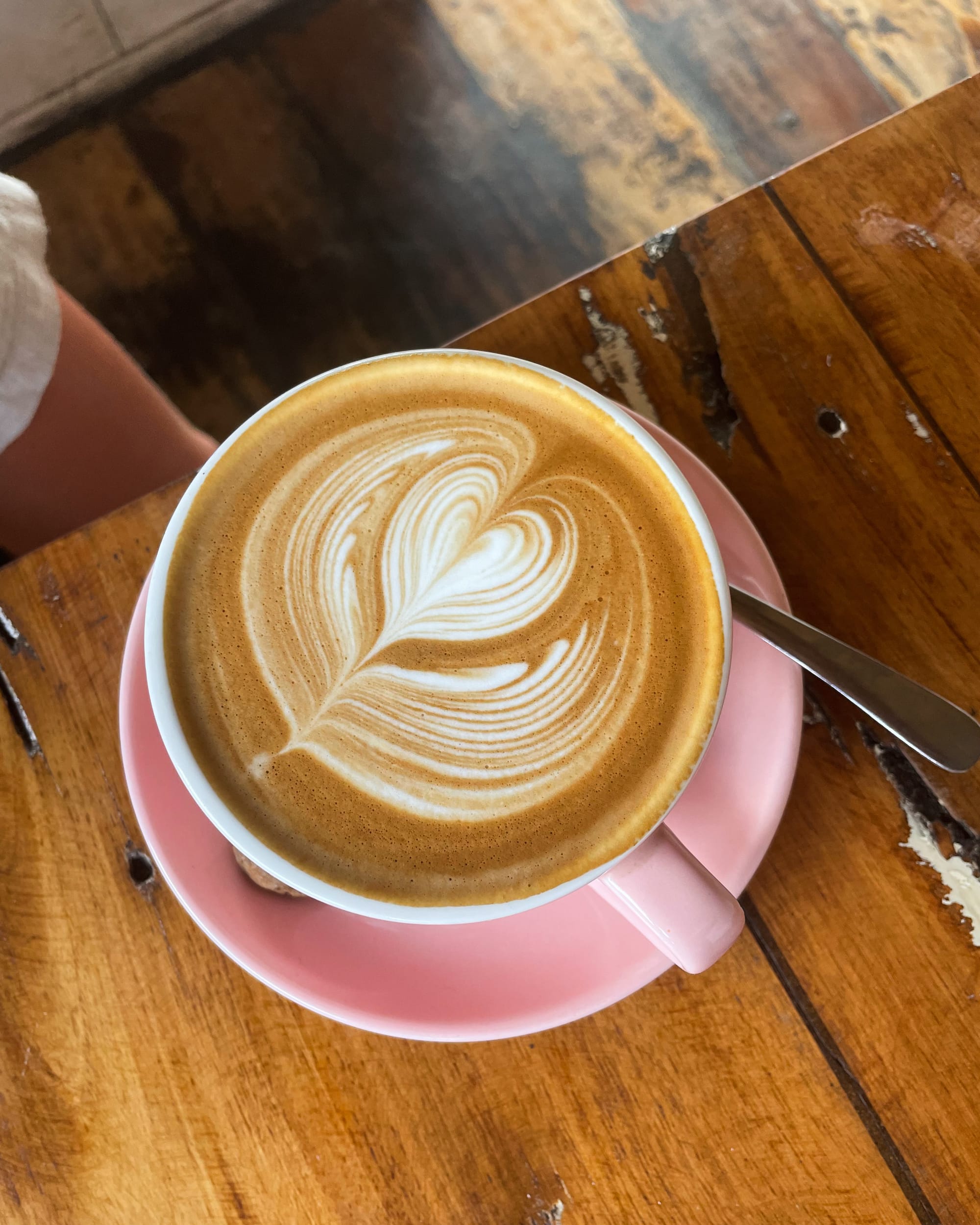 latte with art in a pink mug at Barefoot Blondie