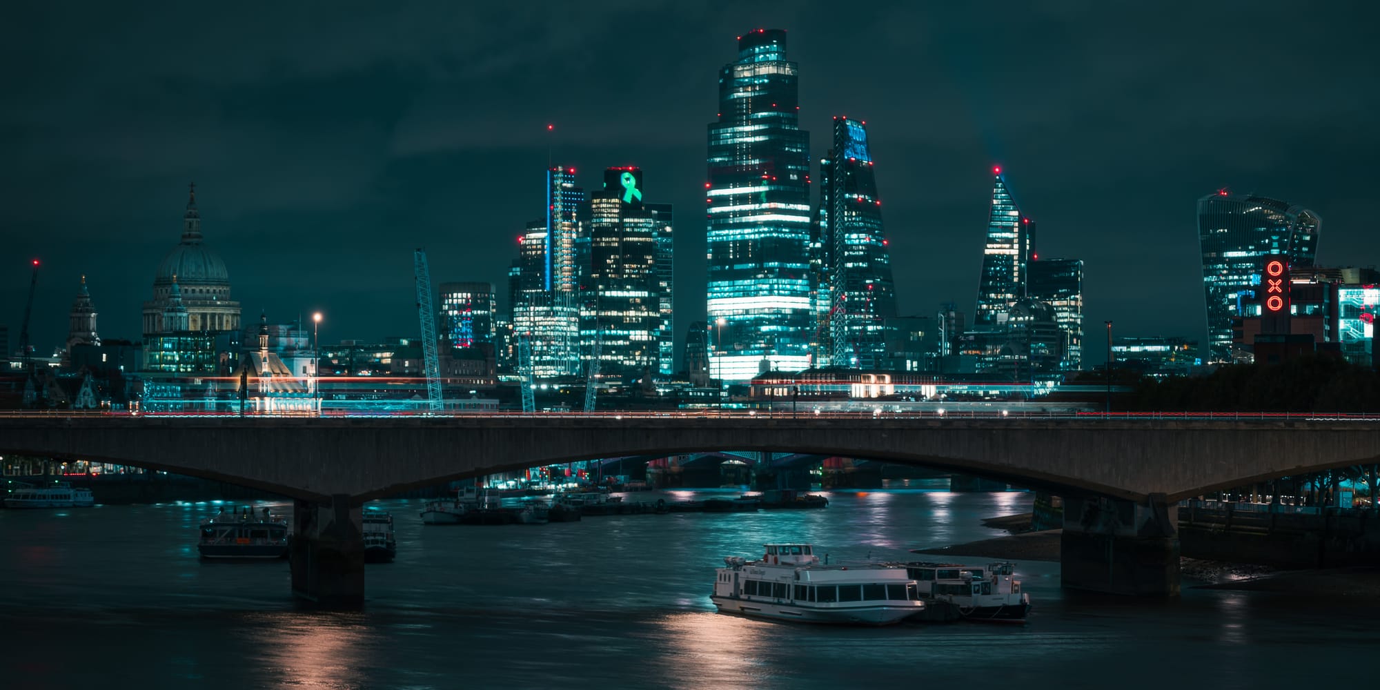 london city skyline lit up at night time