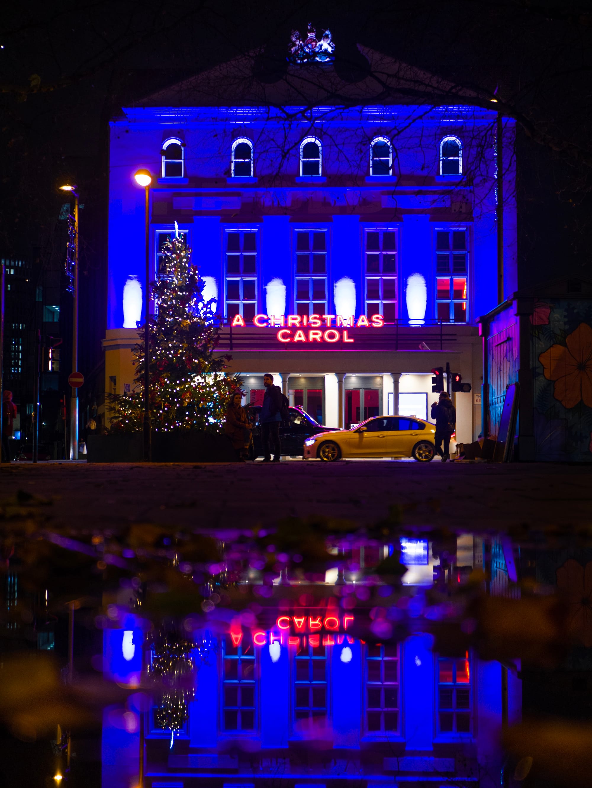 a christmas carol theatre lit up at night in London