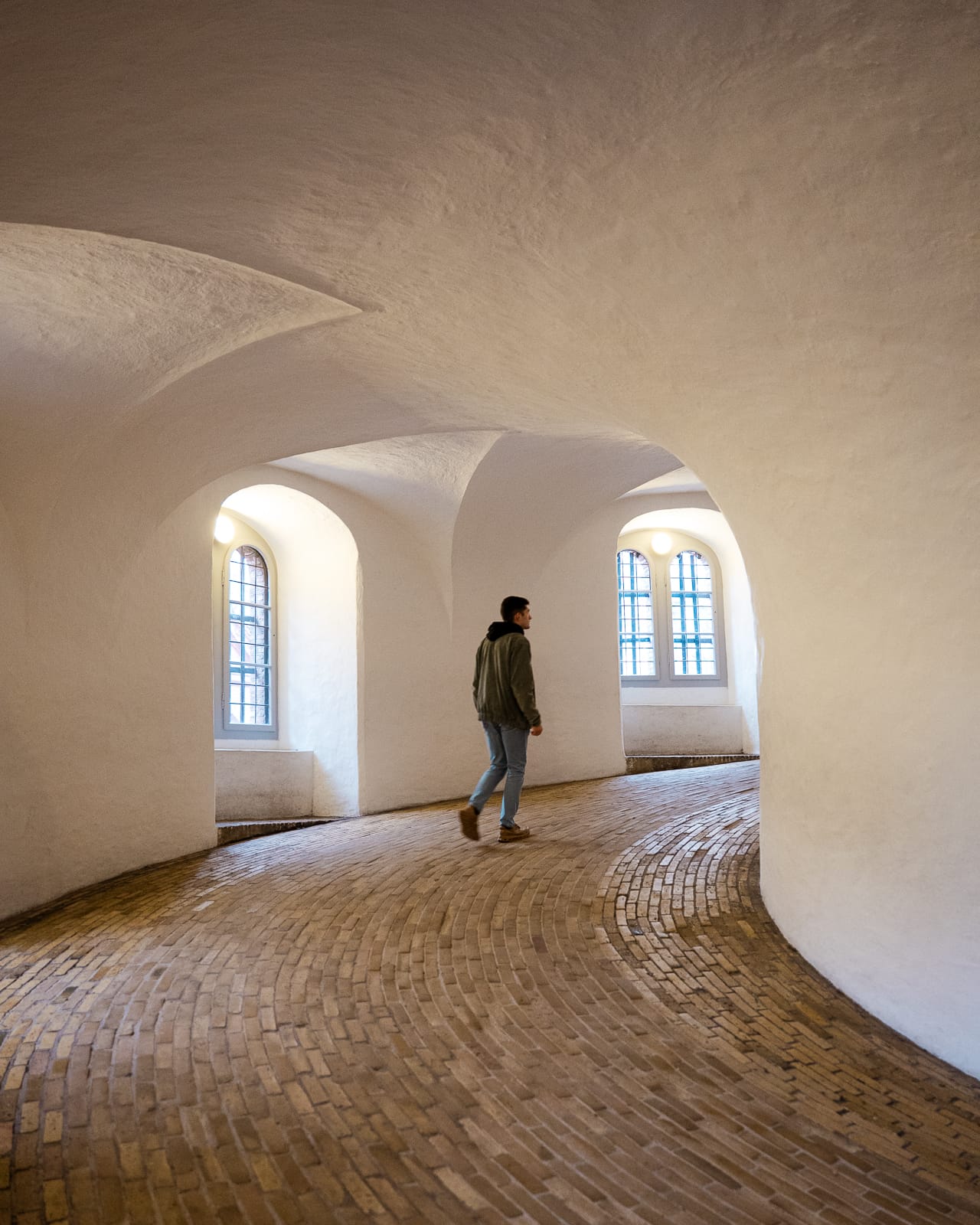 man walking up a ramp in the Round Tower, Copenhagen