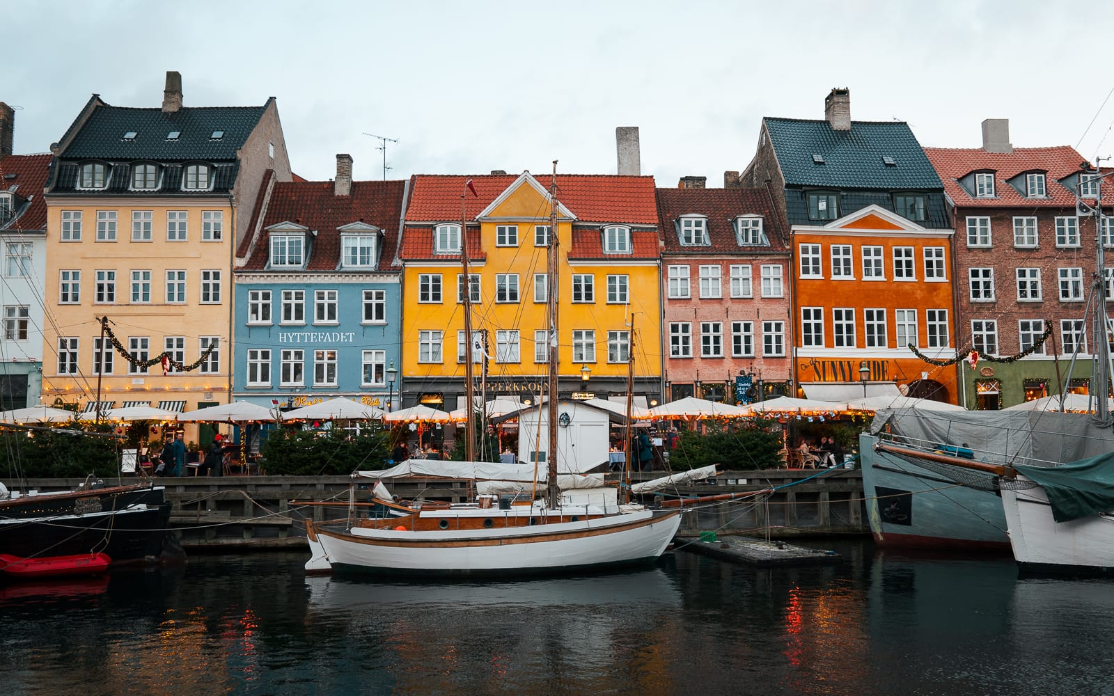 colourful buildings lined up along canal with boats, Nyhaven, Copenhagen