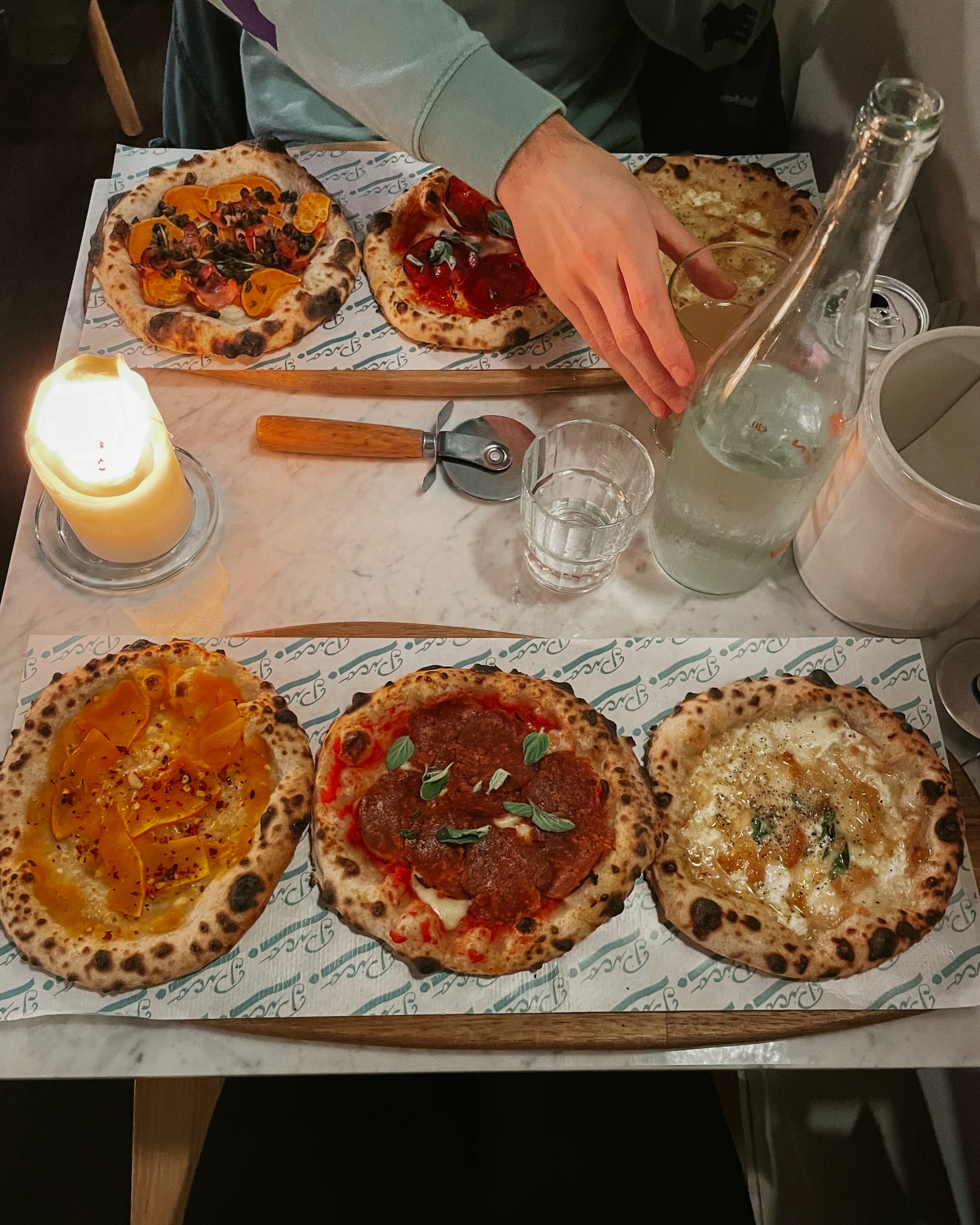 three mini pizzas on a table - pico pizza copenhagen