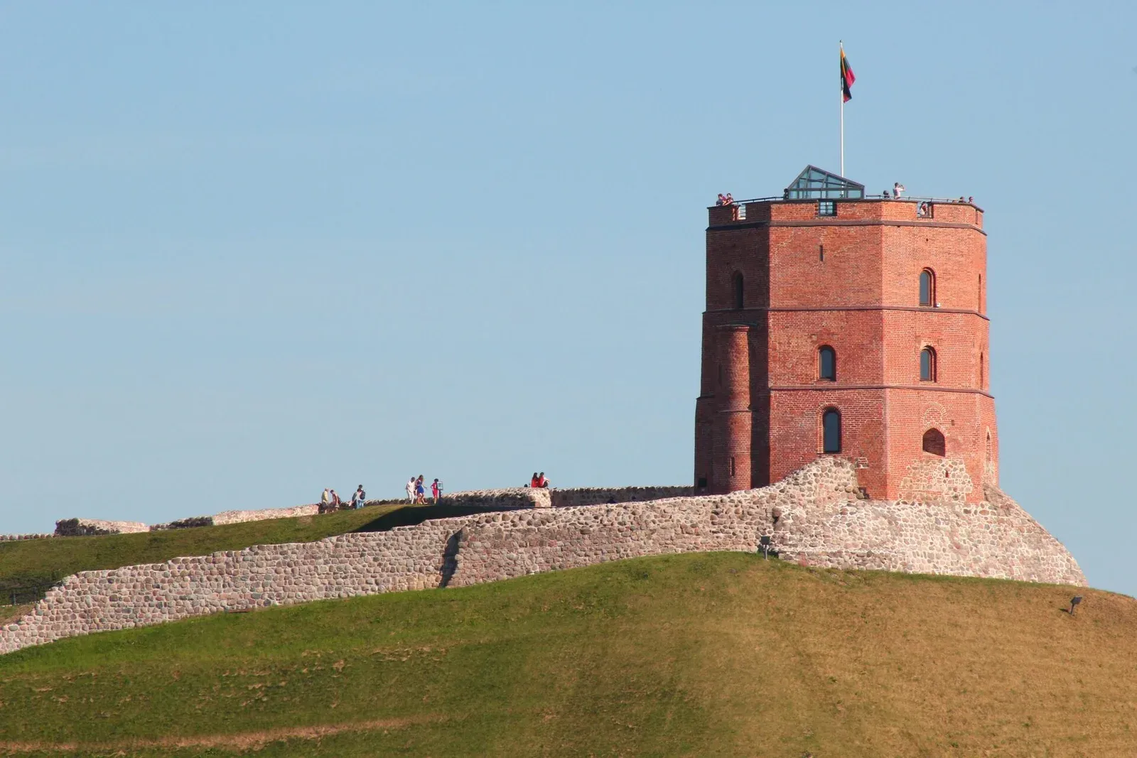 view of gediminas tower and vilnius city behind at sunset