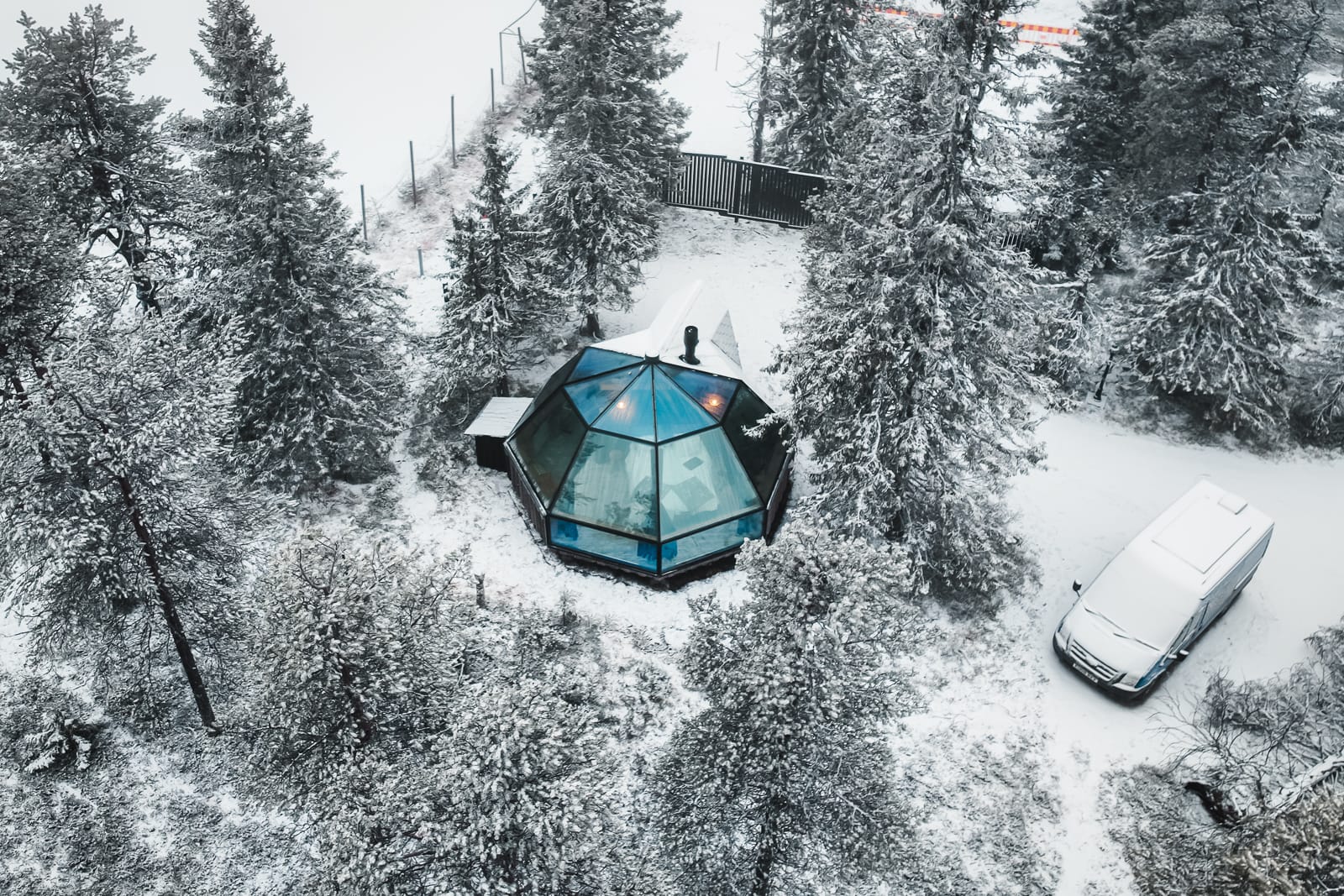 Syote Glass Igloo surrounded by snowy trees in Lapland